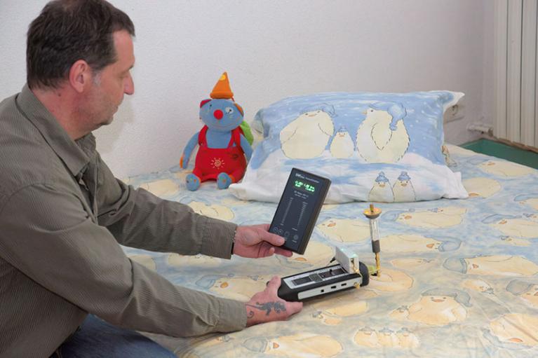 Conseiller agréé LISAO® réalisant l'évaluation de l'environnement électromagnétique d'une chambre.